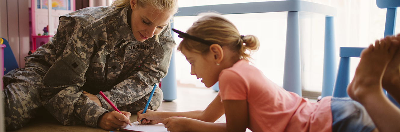 Army Mom Coloring With Her Little Girl
